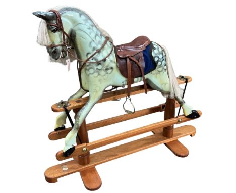 A modern Robert Mullis of Swindon dapple grey rocking horse with tan leather tack on mahogany safety frame, height 116cm