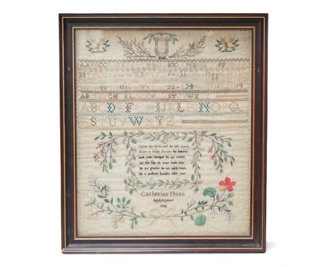 A framed 19th century alphabet sampler by Catherine Noon, dated 1841. Embroidered at the top with a harp and two birds and ro