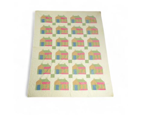 A 1930’s American quilt from Vermont. Quilted in large patchwork ‘house’ motifs, repeating the same four colours in each moti
