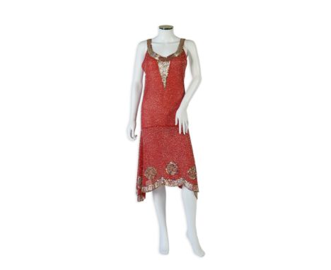 A 1920's red georgette beaded evening dress. Hand beaded and sequinned in white and gold, designed with a dropped waist, hand