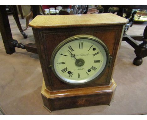 A late 19th Century walnut and brass inlaid mantel clock, painted metal Roman dial signed Camerer Kuss &amp; Co, 8 day striki