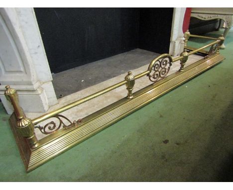 A Georgian style brass and copper fire fender with fluted finial decoration