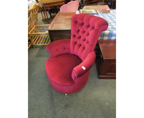 An Edwardian button back claret upholstery tub chair on brass castors, 90cm tall x 70cm wide   