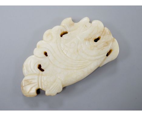 A Chinese white and black jade ‘dragon-fish’ plaque, 19th/20th century, 6cm