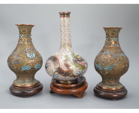 A Chinese cloisonne enamel ‘dragon’ bottle vase, early 20th century and a pair of Japanese cloisonne enamel vases with wood s