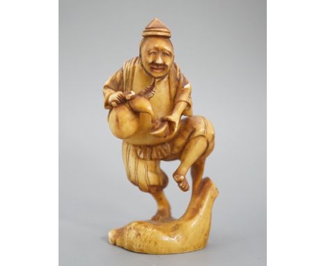 A Japanese ivory okimono of a man dancing and pouring wine from a flask, signed, Meiji period, 7cm