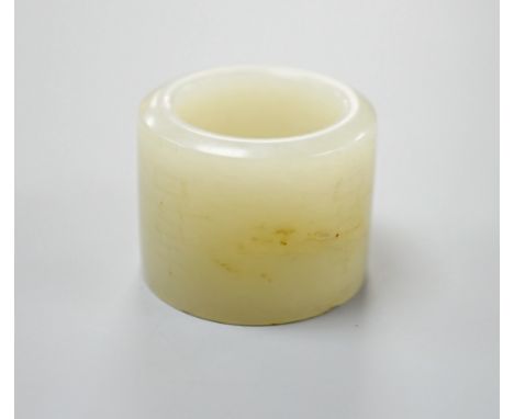 A 19th century Chinese pale celadon jade archer’s thumb ring, inscribed, 3 cm diameter
