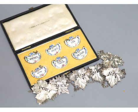 A set of four Victorian silver leaf shaped wine labels, London, 1874, 64mm, one other Victorian silver wine lable, a plated w