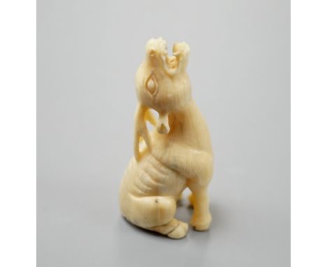 A Japanese ivory netsuke of a seated bellowing deer, 19th century, bears signature, 5.8cm