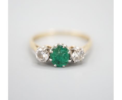 An 18ct and plat, emerald and diamond set three stone ring, size K, gross weight 2.3 grams.