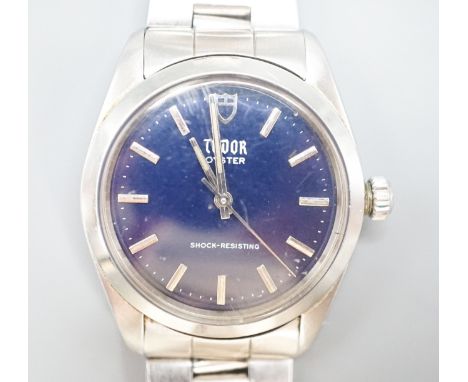 A gentleman's stainless steel Tudor Oyster manual wind wrist watch, with blue dial, on Rolex bracelet, case diameter 34mm, no