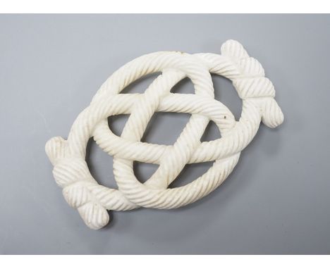A Chinese hardstone eternal knot carving, 19th century, possibly burnt jade, 8.4cm
