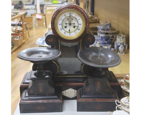 A 19th century Victorian slate clock garniture, the movement with visible Brocot escapement with keys and pendulum (af), cloc