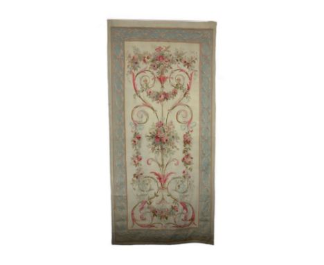 A large 19th century Aubusson entre fenetre tapestry wall panel,woven with a vase of flowers scrawling leaves and tendrils, t