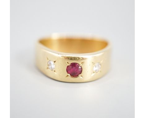 An 18ct and gypsy set three stone ruby and diamond ring, of triangular form, size O/P,gross weight 8.3 grams.