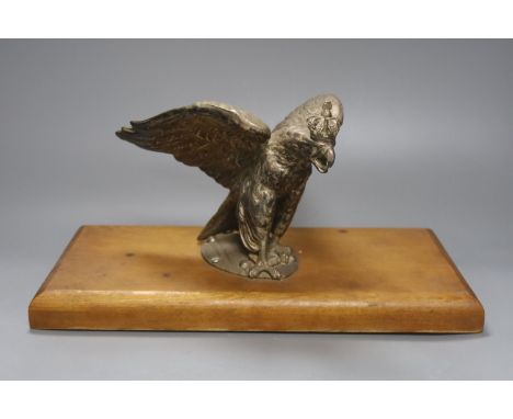 A plated Prussian eagle finial for a Prussian Guard’s helmet, later wood plinth, W36cm