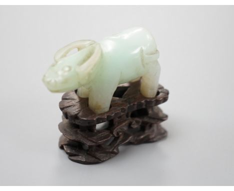 A small Chinese jade figure of a buffalo, late 19th/early 20th century, 3.8cm long, wood stand