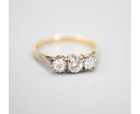 A modern 18ct gold and three stone diamond ring, size Q/R, gross weight 3 grams.