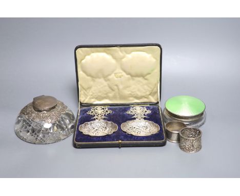 A glass silver mounted inkwell, 2 napkin rings boxed silver dishes and an enamel box