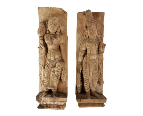 TWO CARVED WOOD PILASTERS, INDIA, 19TH CENTURY, each carved in high relief with a deity, 44cm high approx Provenance: The Col