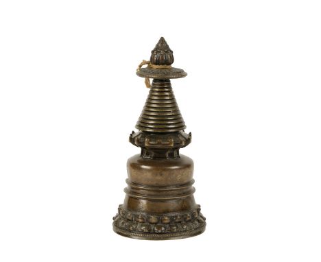 BRONZE STUPA, TIBET, 13TH CENTURY OR LATER, the domed base with a double lotus petal foot, surmounted by a stepped temple for