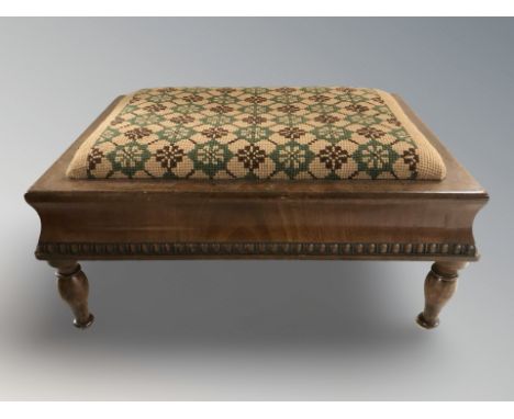 An early 20th century mahogany needlepoint footstool, width 38 cm.