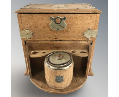 An oak smoker's cabinet with tobacco jar, width 34 cm.