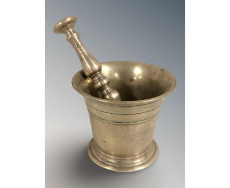 An early 19th century bronze mortar and pestle, mortar 10 cm high.