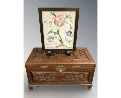 An oriental heavily carved blanket chest, 88 cm x 44 cm x 47 cm and a tapestry fire screen 