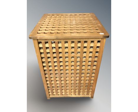 A teak lattice laundry hamper, width 46 cm, and a metal framed lamp table with pine block top.