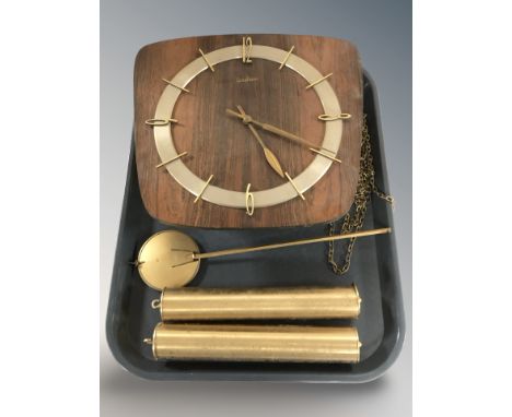 A Junghans wall clock with pendulum and weights.