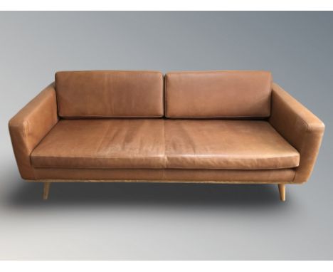 A contemporary Scandinavian stitched tan leather four seater settee, 202 cm x 93 cm x 70 cm.