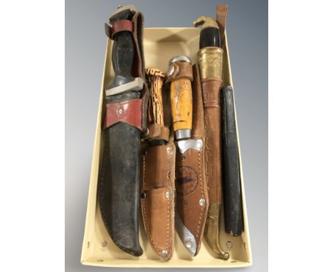 A group of hunting and other knives, cutthroat razor in box.