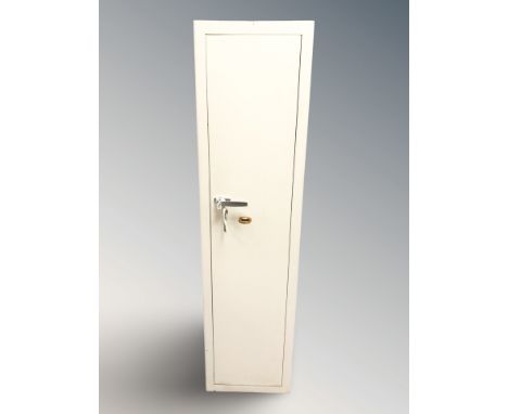An enameled metal gun cabinet with internal ammunition compartment, with keys, 38 cm W x 31 cm D x 150 cm H.