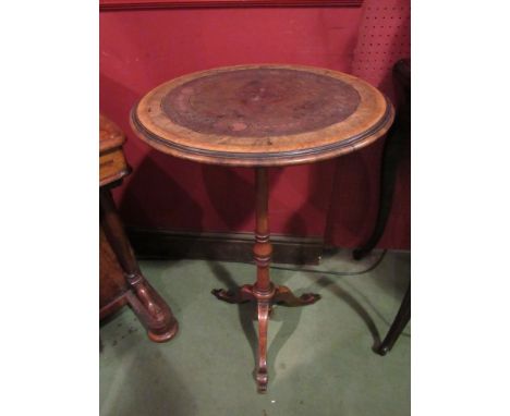 A 19th Century Continental walnut tripod wine table of tall proportions, with tooled leather top and turned column