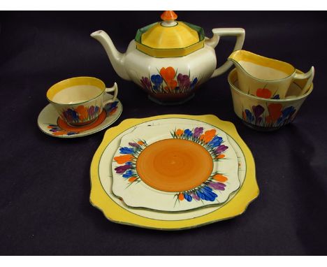 A Clarice Cliff Bizarre Crocus pattern teapot, milk jug, sugar bow, large plate, six small plates, cups and saucers 