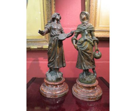 A pair of early 20th century Spelter figures, one holding a lute, on a stepped painted base, 37cm tall