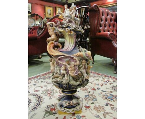 A Majolica style covered ewer, applied with all over nautical decoration of shells, Neptune, dolphins, horses and figures, so