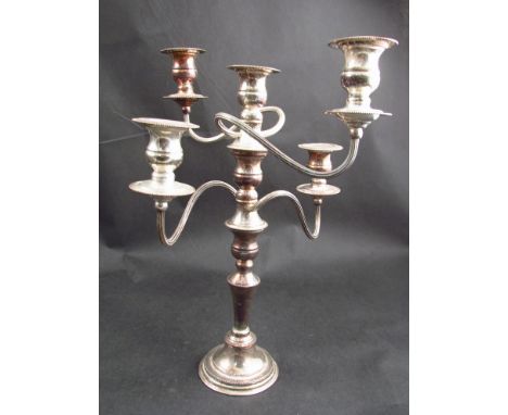 A silver on copper four branch candlestick with beaded detail 