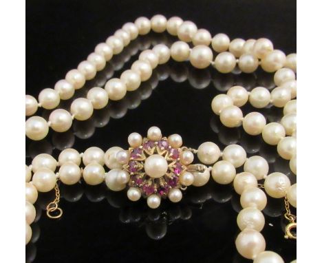 A two row graduated necklace with ruby and pearl 9ct gold clasp