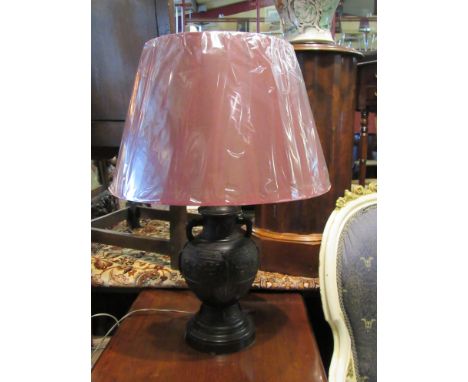 A Chinese style bronzed urn form table lamp base with burgundy shade.   DTI Failure: Please See Information Pages