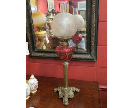 A Best British make faceted cranberry glass oil lamp of Art Nouveau form 