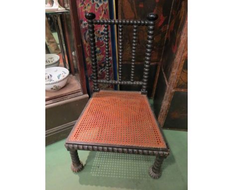 A Victorian ebonised bobbin turned chair with cane seat 