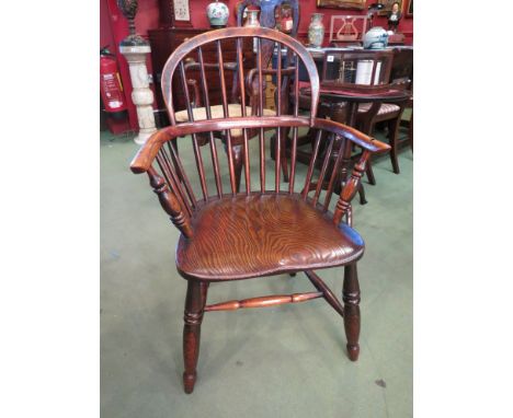 A circa 1840 ash low stick back Windsor elbow chair with elm seat on turned legs joined by an "H" stretcher 