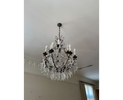 A contemporary metal framed chandelier. The two upper tiers having eight branches, each supporting glass droplets, the lowest