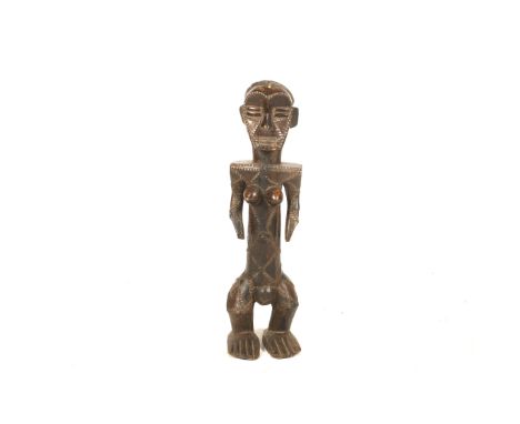 Ethnographic Tribal Art - an African tribal carving of a female fertility figure. Of standing form, elongated torso with a fa