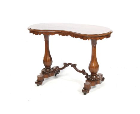 A Victorian mahogany veneered kidney shaped console table. With octagonal baluster twin supports united by a carved stretcher