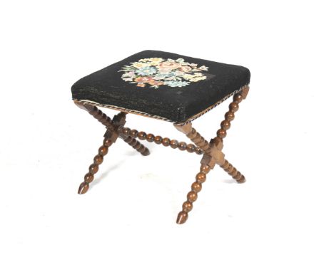 A 19th century bobbin turned X framed stool. The rectangular floral embroidered seat. L44cm x D44cm x H42cm