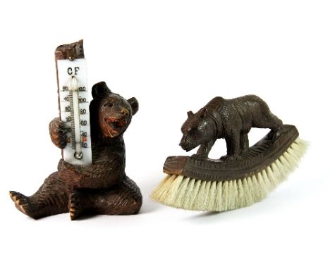 A carved wooden Black Forest bear thermometer (13cm) and brush