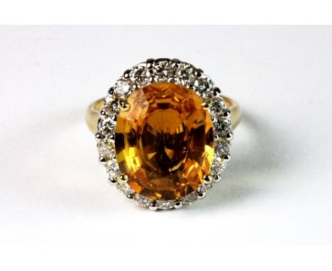 18ct yellow gold ring set with a 9.13ct yellow sapphire and mounted by over 1ct of diamonds (P). Est. &pound;1500 - 2000